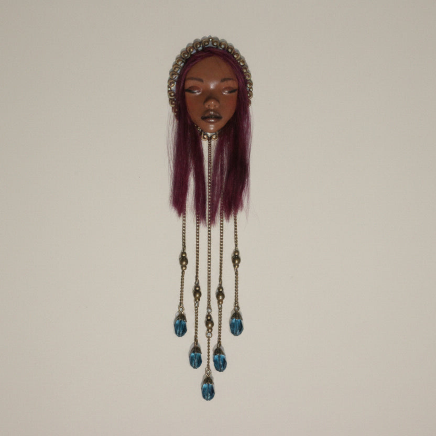 Handmade wall piece with original face sculpture and crystal beads hanging from chains